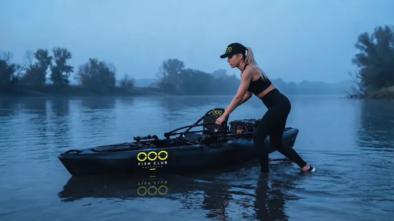 Member launching an OOO kayak at dawn